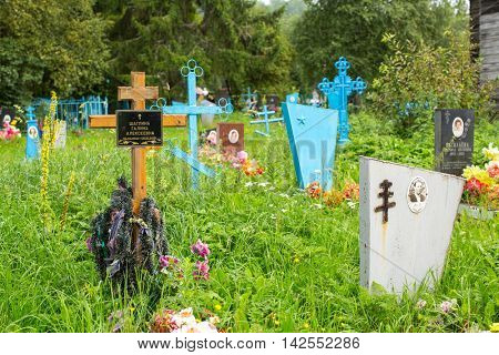 SOGINICY, RUSSIA - JUL 30, 2016: Cemetery on site of Church of Nichola. Church of St. Nicholas at Soginicy, the only surviving sample of a steepled Church prionezhskiy school, 1696 built.