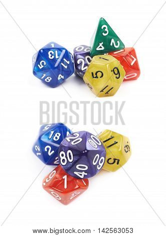 Pile of colorful roleplaying polyhedral dices isolated over the white background, set of two different foreshortenings