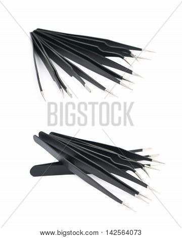 Pile of black metal anti-static tweezers tools isolated over the white background, set of two different foreshortenings