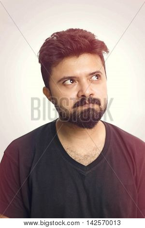 Young Men Wearing Black T Shirt Looking Up And Thinking - Isolated
