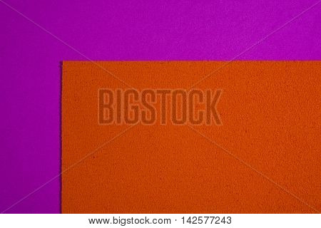 Eva foam ethylene vinyl acetate sponge plush orange surface on pink smooth background