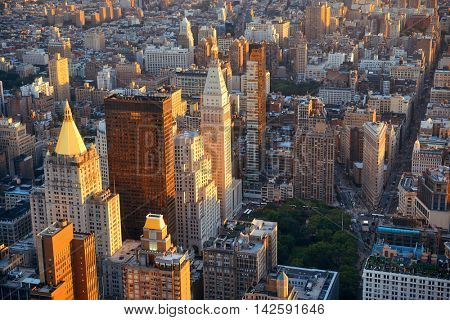 New York City rooftop view with downtown Manhattan skyscrapers and urban cityscape.