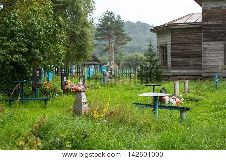 SOGINICY, RUSSIA - JUL 30, 2016: Cemetery on site of Church of Nichola. Church of St. Nicholas at Soginicy, the only surviving sample of a steepled Church prionezhskiy school, 1696 built.