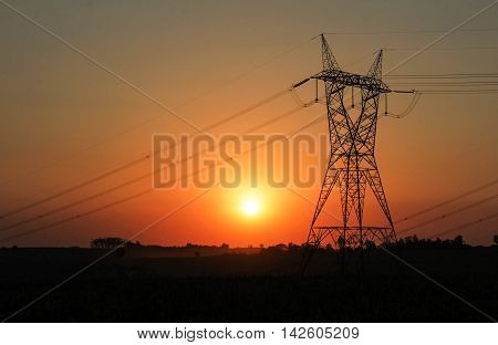 Eletricity tower providing energy distribution over sunset