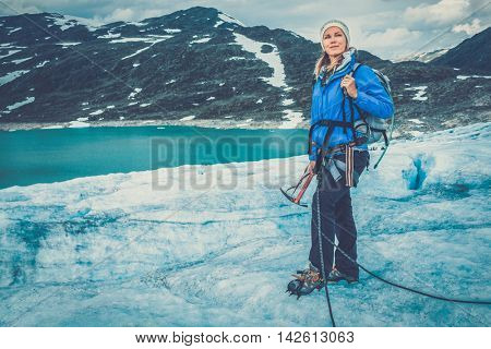 Woman climber standing on Jostedalsbreen glacier. Norway.