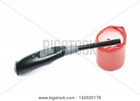 Utility long-neck black plastic lighter next to a red wax candle, composition isolated over the white background