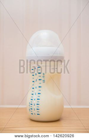 baby bottle of powdered milk at home close up