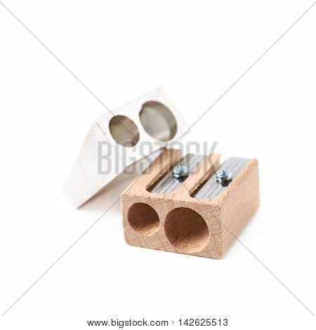 Two, metal and wooden pencil sharpeners, composition isolated over the white background