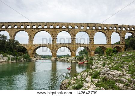 Pont du Gard in Provence France over the Gardon river is an 160 foot high roman aqueduct built to provide water to the city of Nimes from the river Eure near Uzes in the first century A.D.