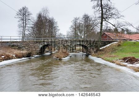old stonebridge over the cold water one grey day in early spring