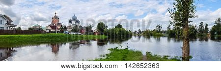 Panorama Tikhvin male monastery - it is Tikhvin icon of the mother of God. The Orthodox Church of Russia. The temple on the banks of the Tikhvinka river in Tikhvin.