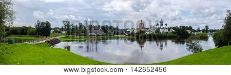Panorama Tikhvin assumption male monastery - it is Tikhvin icon of the mother of God. The Orthodox Church of Russia. The temple on the banks of the Tikhvinka river in Tikhvin.
