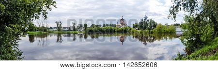 Panorama of Tikhvin assumption male monastery, it is the Tikhvin icon of the mother of God. The Orthodox Church of Russia. The temple on the banks of the Tikhvinka river in Tikhvin.