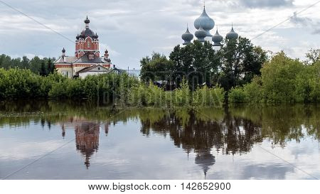 Panorama of Tikhvin assumption male monastery, it is the Tikhvin icon mother of God. The Orthodox Church of Russia. The temple on the banks of the Tikhvinka river in Tikhvin.