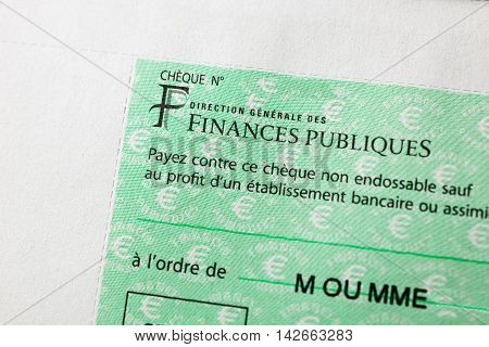 PARIS FRANCE - JAN 14 2016: Detail of French Cheque issued by the Direction Generale des Finances Publiques - the division f Economic Minister responsible for income taxes