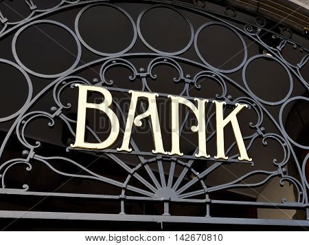 Old fashioned bank sign, building exterior of a bank with wrought iron.