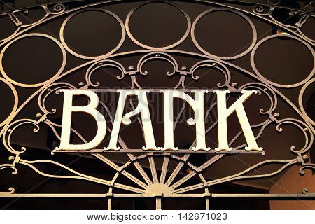 Old fashioned bank sign, building exterior of a bank with wrought iron.
