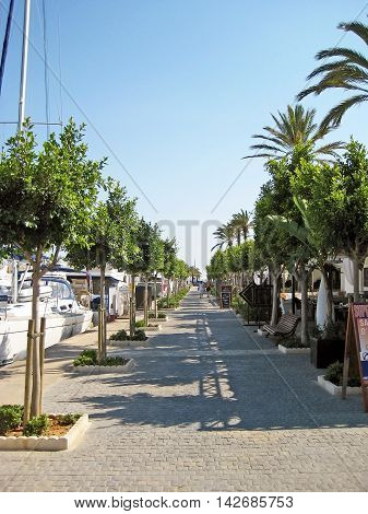 Alcudia Majorca Spain - June 26 2008: Habor promenade of Alcudia with restaurants on the right and boats on th left