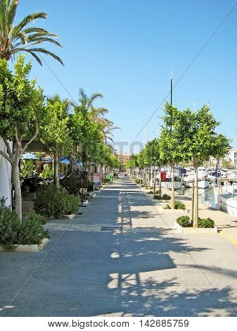 Alcudia Majorca Spain - June 26 2008: Habor promenade of Alcudia with restaurants on the left and boats on the right