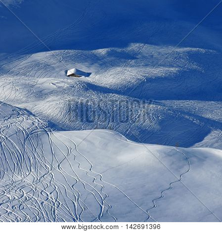 Winter scene in Stoos Swiss Alps. Ski and snowboard tracks in powder snow.