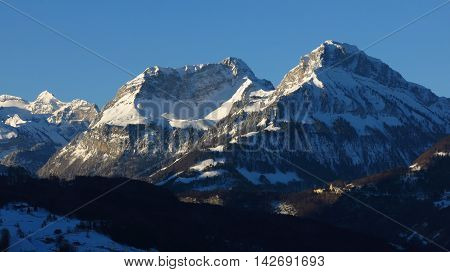 Snow covered mountains on a winter morning. View from Schwyz. Mt Schwalmis and Mt Brisen.