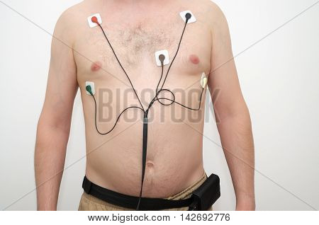A man wearing a holter monitor device