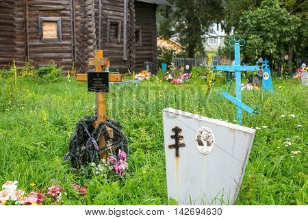 SOGINICY, RUSSIA - JUL 30, 2016: Cemetery on site of Church of Nichola. Church of St. Nicholas at Soginicy, the only surviving sample of a steepled Church prionezhskiy school, 1696 built.