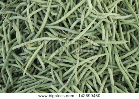 Green beans in bulk on a rural market.