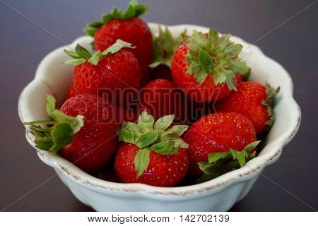 Strawberries galore, bowl full of delicious, red fruit