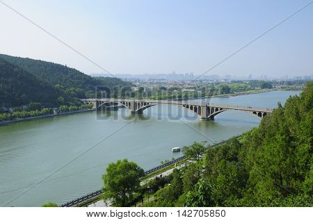 The Longmen Bridge over the Yi River at Longmen Grottoes in Luoyang China in Henan Province.