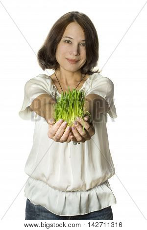 Beautiful smiling woman on grass in hands - nature protection