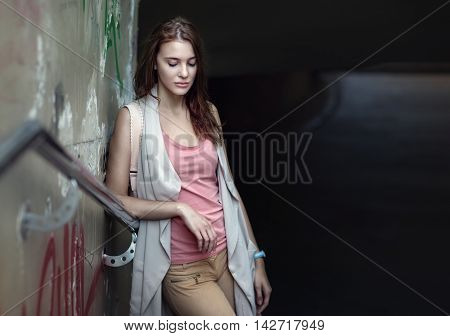 Young beautiful sad teen in urban background