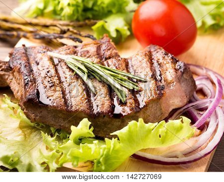 Beef steak with fresh herbs and tomatoes