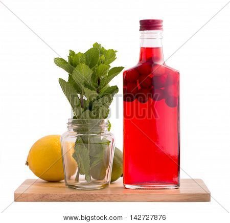 Bottle of cranberry drink with mint and lemon isolated on white