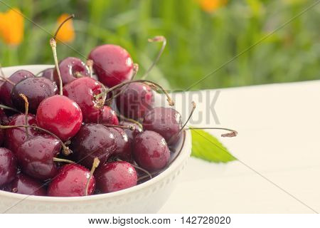 Bowl of cherry berries in on table closeup