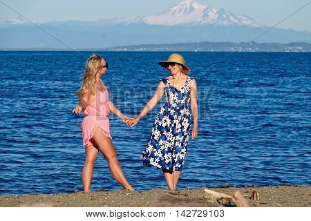 Mother and daughter on beach. Centennial Beach at Boundary Bay Regional Park Tsawwassen British Columbia Canada.