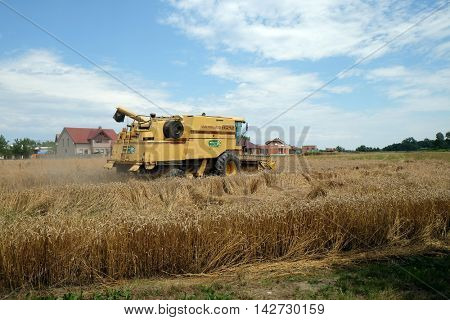 TRNOVEC, CROATIA - JULY 09, 2016: Combine harvester harvest ripe wheat on a farm in Trnovec, Croatia on July 09, 2016