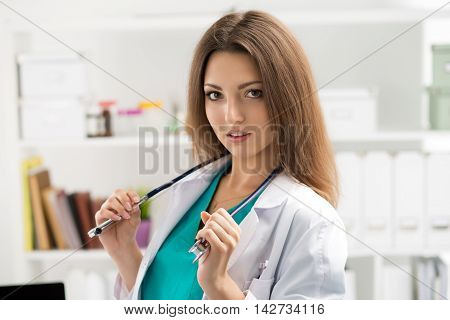 Female medicine doctor taking of her stethoscope ready to examine her patient. Healthcare medical care insurance prescription service or education and healthy lifestyle concept