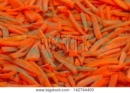 Closeup of chopped carrots with pepper in a large bowl