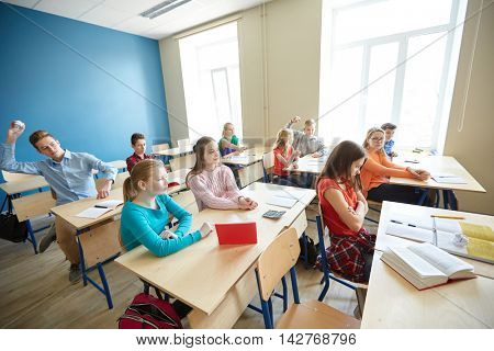 education, bullying, conflict, problem and people concept - students gossiping behind classmate back at school