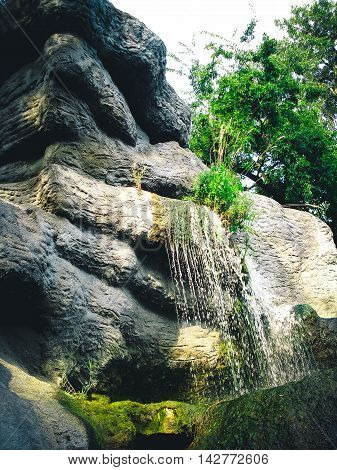 small waterfall of stones against the sky