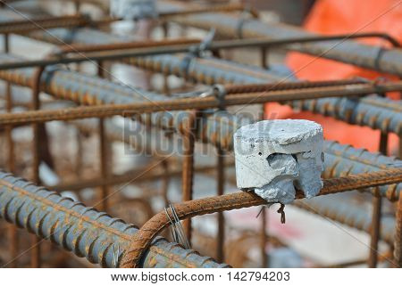 SELANGOR, MALAYSIA -SEPTEMBER 19, 2015: Hot rolled deformed steel bars or steel reinforcement bar and the concrete spacer. The spacer used to created gap between reinforcement bar and the form work.