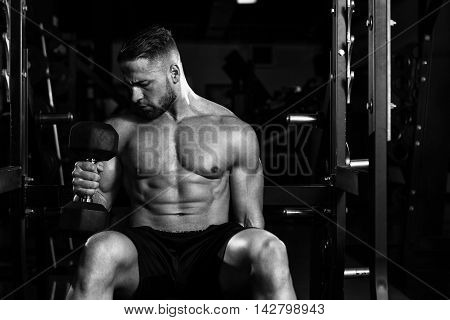 Young Man With Dumbbells Exercising Biceps