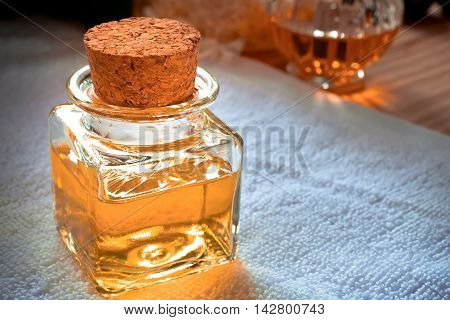 Bottle of aroma essential oil on white towel