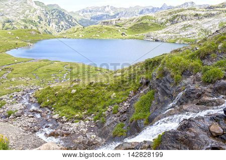 Ayous Lake And A Waterfall In Summer In Pyrenees, France