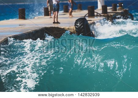 Strong Winds And Waves Are Hitting A Pier In Harbor. Port In Silba