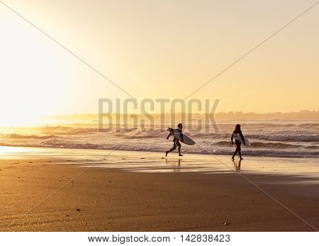 Beautiful beach lansdscape with surfers ready to hit the waves