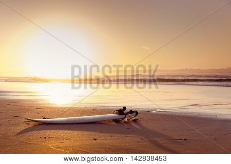 Beautiful beach lansdscape with a surfboard in the sand