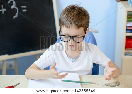 7 Years Old Boy Counting On Fingers.