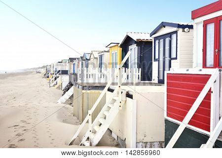 beach huts or houses and clear blue sky. Multicolored beach huts in in a row.